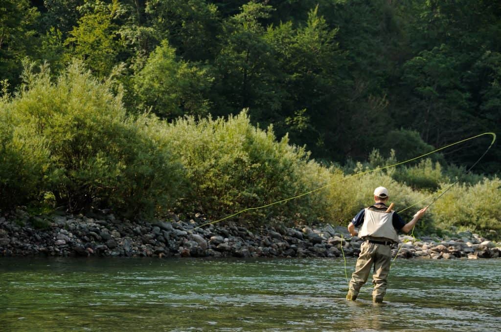 fly fishing in a mountain stream with fast current